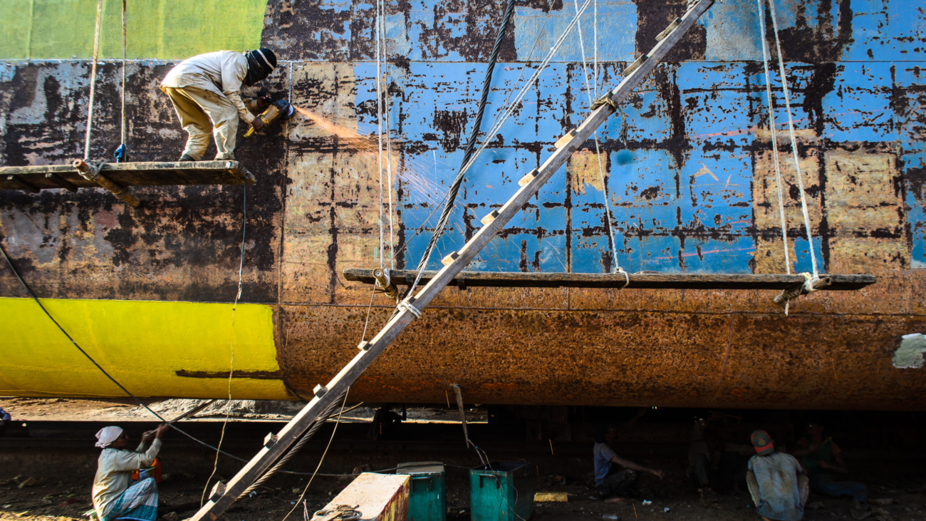 Workers welding parts of ship in bangladesh